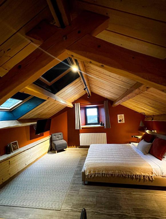 a bedroom with a large bed in an attic at La Ferme du Bien-etre in Saint-Julien-Chapteuil