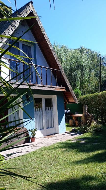 a blue and white house with a porch at Chalet para 7 en Mar del Plata con parque y parrilla in Mar del Plata