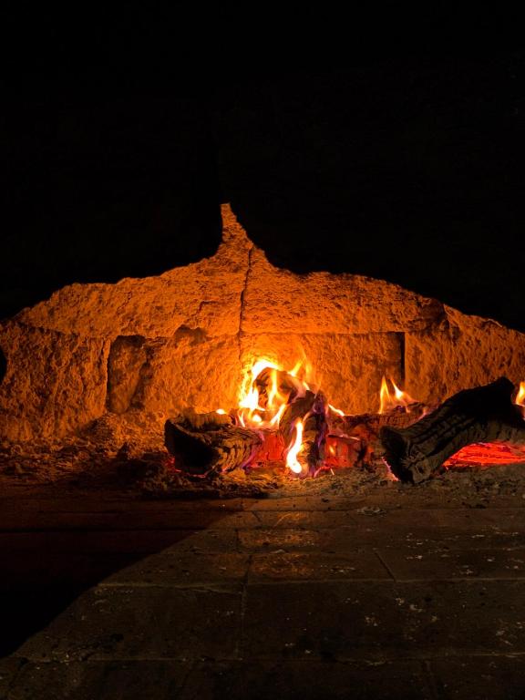 a fire burns in a stone oven at night at La Ferme du Bien-etre in Saint-Julien-Chapteuil