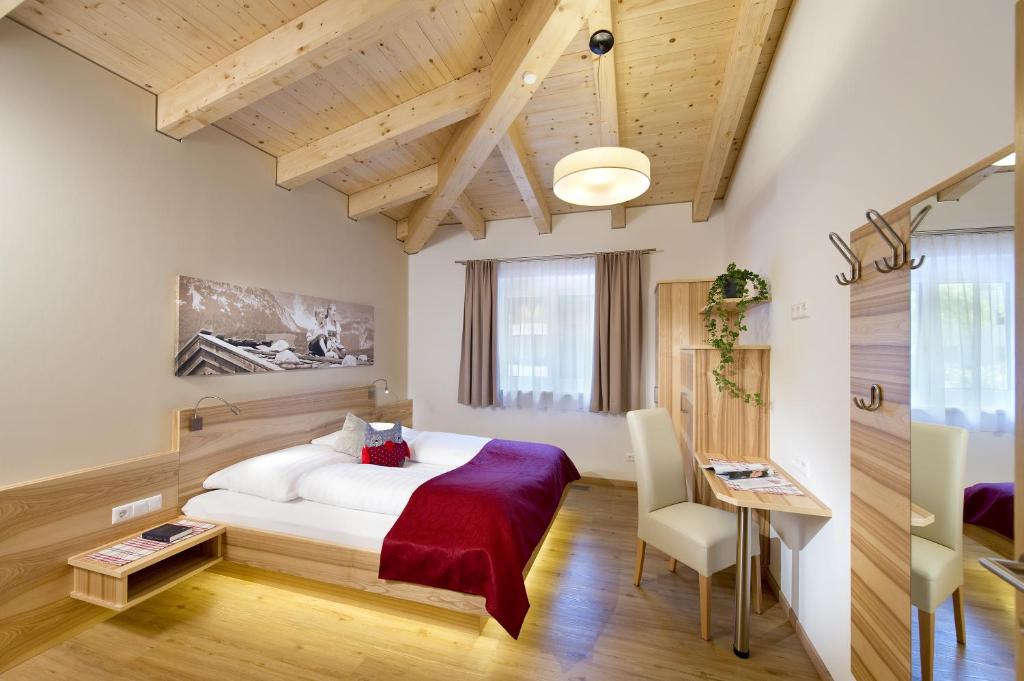 a hotel room with a bed and a desk at Apartment Dorfjuwel in Oberau