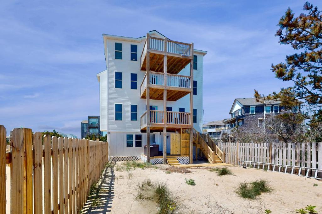 a house on the beach with a wooden fence at Seabreeze Shores 1 in Rodanthe