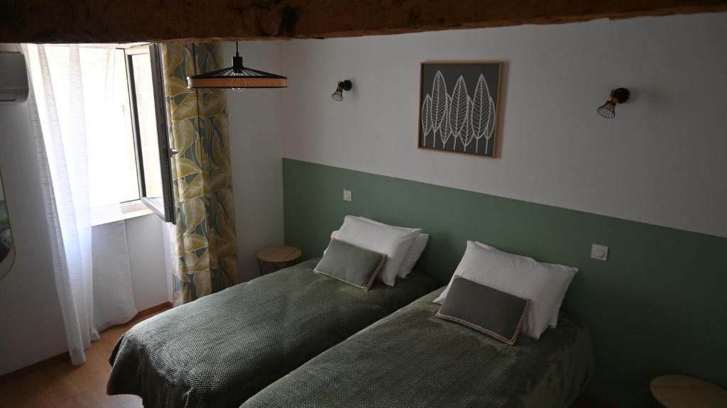 Postel nebo postele na pokoji v ubytování Les Gites d'Andréa - Chez Madame Yvon