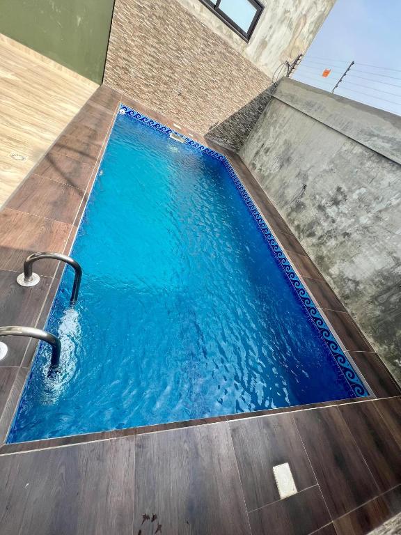 a swimming pool with blue water in a building at Sublime Villa in Cotonou