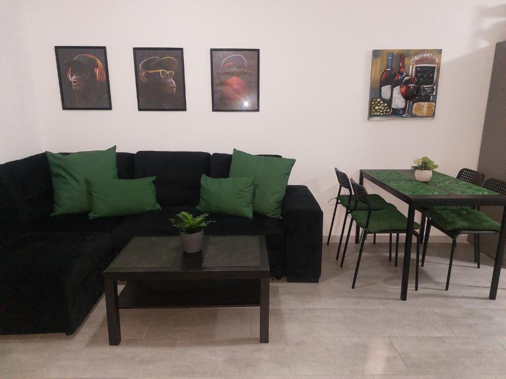 a living room with a black couch and a table at Apartment Caleta de Fuste in Caleta De Fuste
