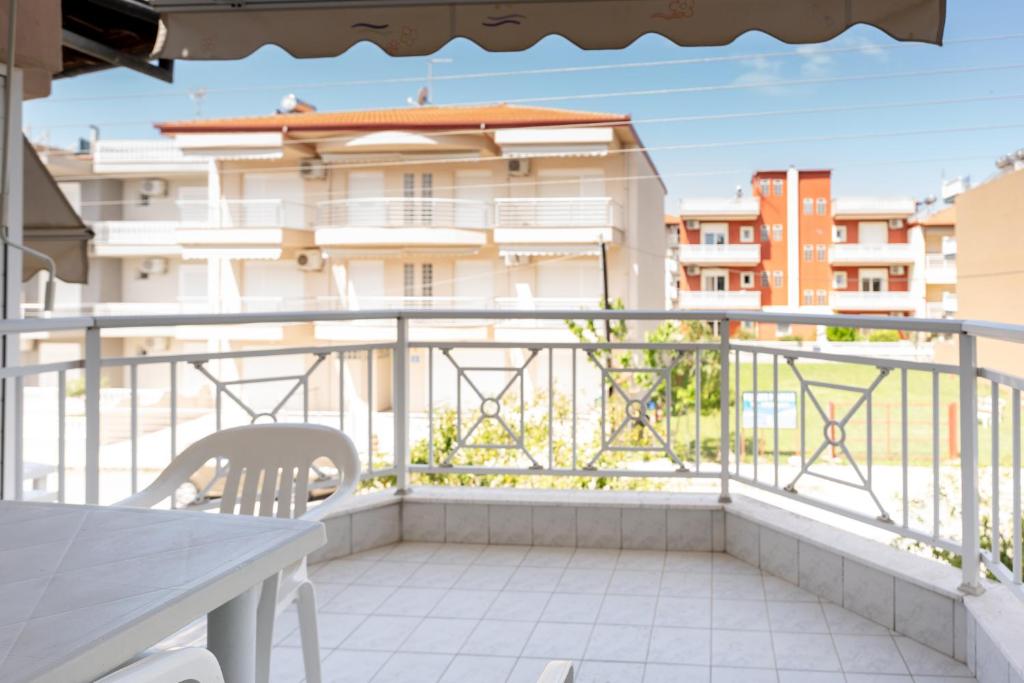 a balcony with a table and a view of a building at Villa Zeus INN in Paralia Katerinis