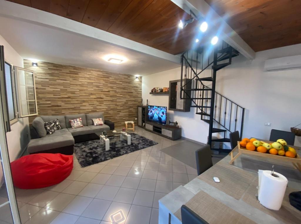 a living room with a couch and a staircase at mario's home in Pula