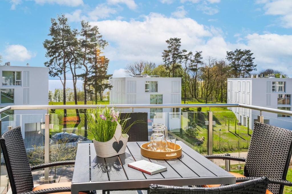 a patio with a table and chairs on a balcony at Apartment "Haffliebe" - Haffresidenz in Garz