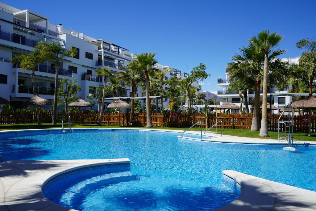a large swimming pool in front of a building at Aguacate Beach Apartamentos Playa Granada in Motril
