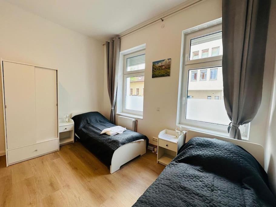 a bedroom with two beds and a window at Comfortable studio in Berlin5 in Berlin