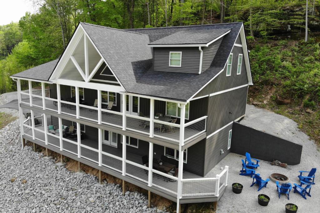 an aerial view of a large house with chairs at Rough River Lake House with Dual Primary Suites! in Fentress McMahan