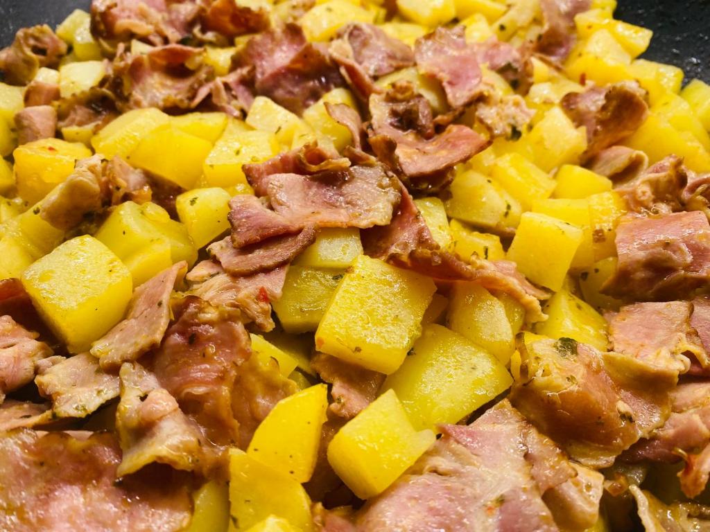 a close up of a plate of food with meat and pineapple at Dreams beach hostel in Dubai