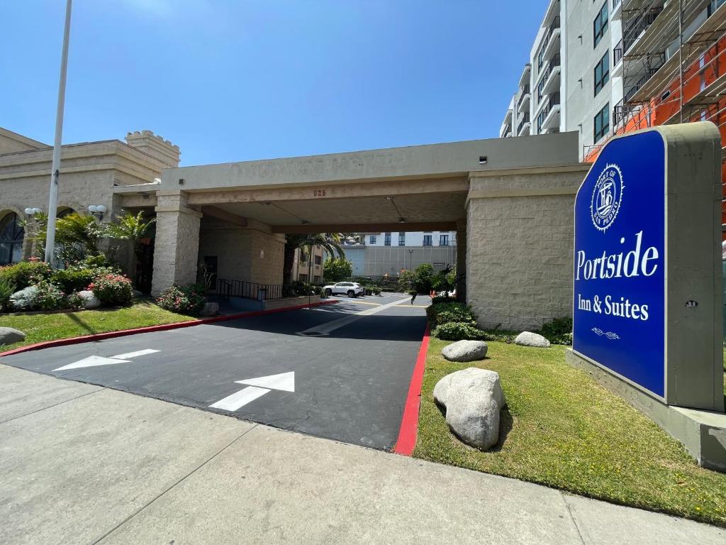 a parking garage with a sign in front of a building at Portside Inn & suites in San Pedro