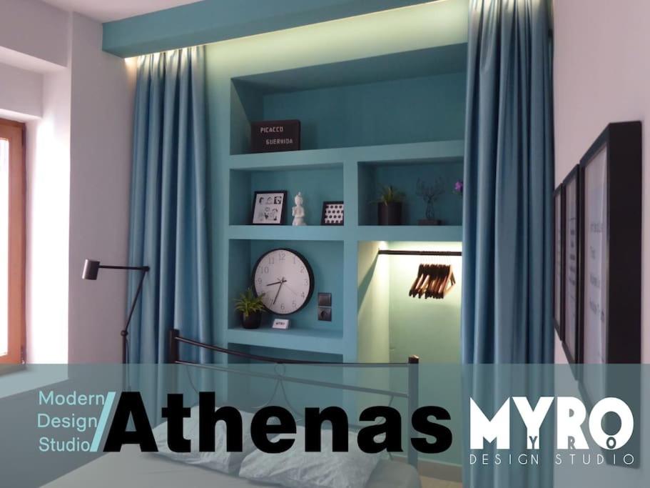 a room with a clock on a blue wall at #Athenas Modern Design studios in Mytilini