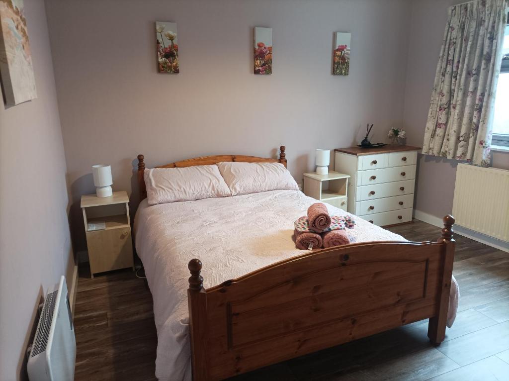 a bedroom with a bed with two teddy bears on it at The Croft Apartment in Westport