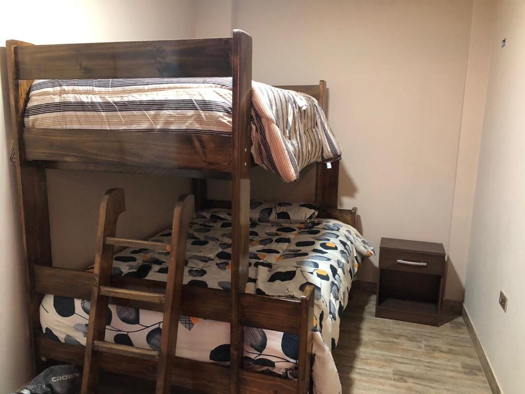 a bedroom with a bunk bed with a cow print at Big blue house in Chimbote