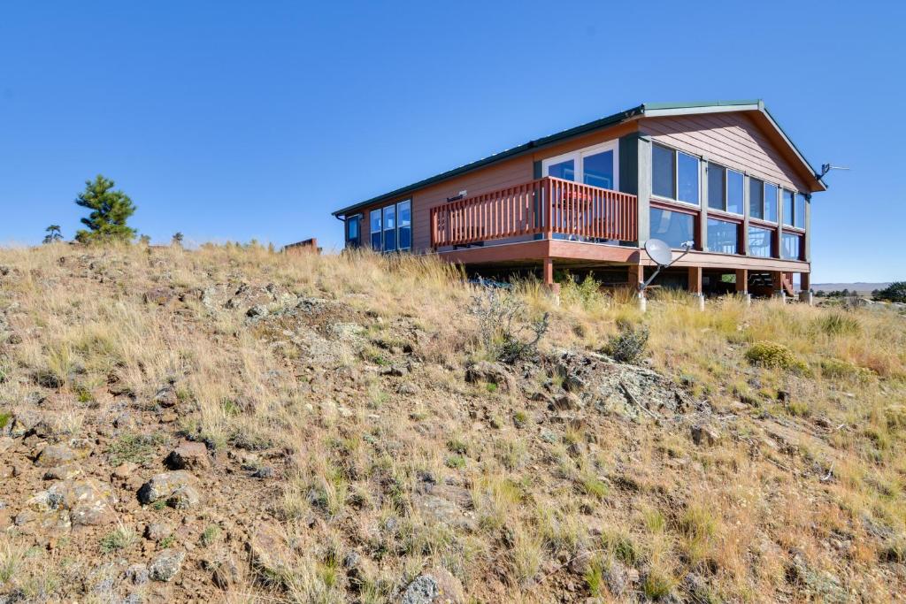 a house on the side of a hill at Tranquil Cabin Getaway w/ Panoramic Mtn View! in Antero Junction