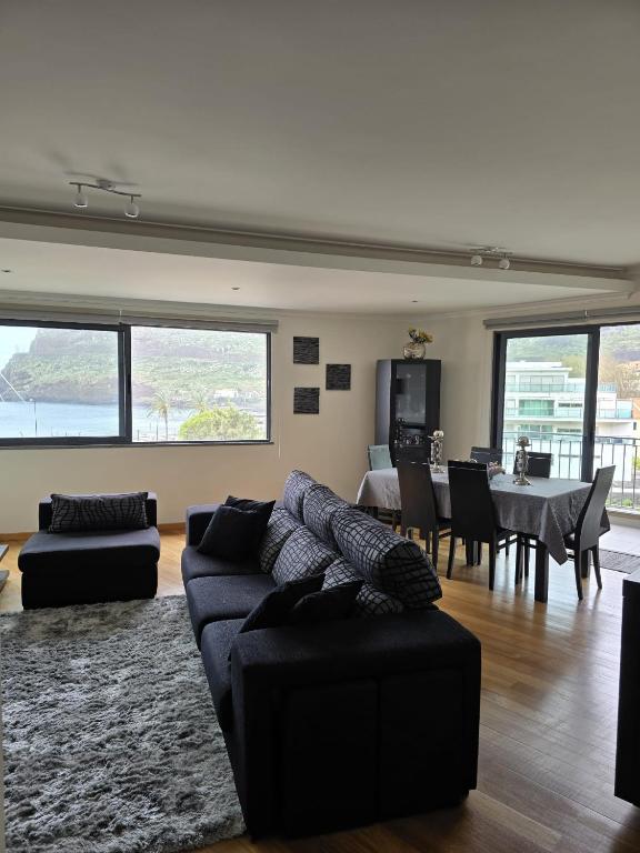 a living room with a couch and a dining room at VIP Paradise Apartment in Machico