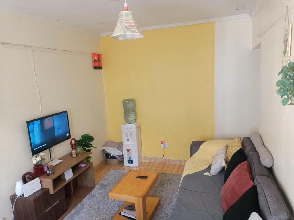 a living room with a couch and a tv at Nalelek Homes in Narok