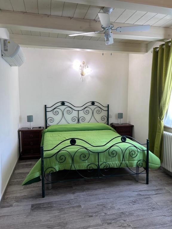 un letto verde in una camera con soffitto di A Casa di Lory a Senigallia