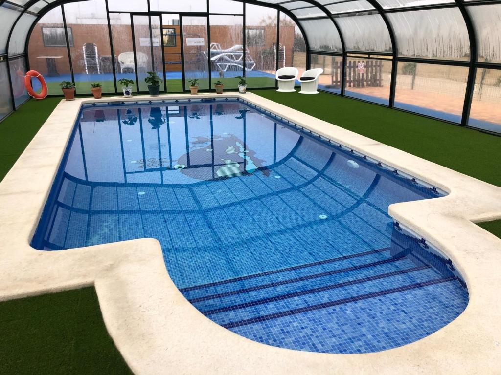 una gran piscina en una casa verde con piscina en La Escapada, en Minaya