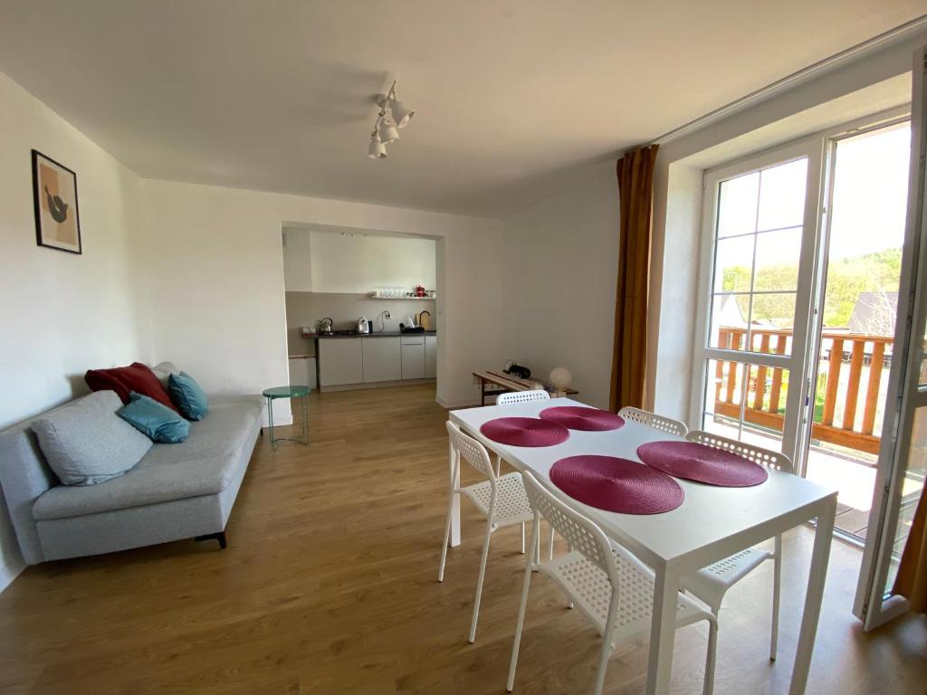 a living room with a table and a couch at PrzyLądek Zdrój Bike Apart in Lądek-Zdrój