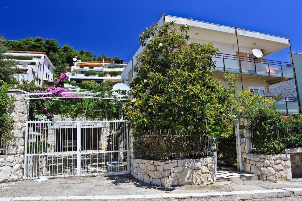 a white gate in front of a building at Meje Apartments in Split