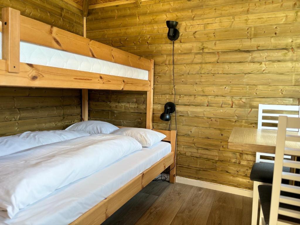 a bedroom with two bunk beds and a desk at Winjum Cabin Aurland Stegastein in Aurland