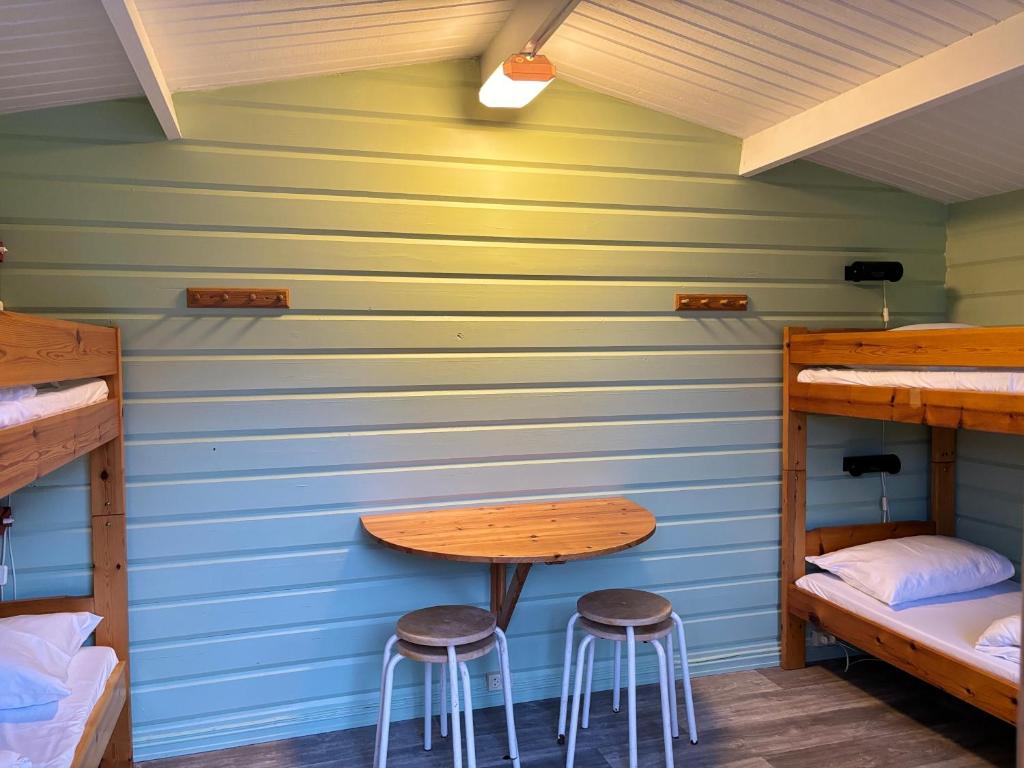 a room with two stools and a table in a room at Winjum Cabin Aurland Stegastein in Aurland