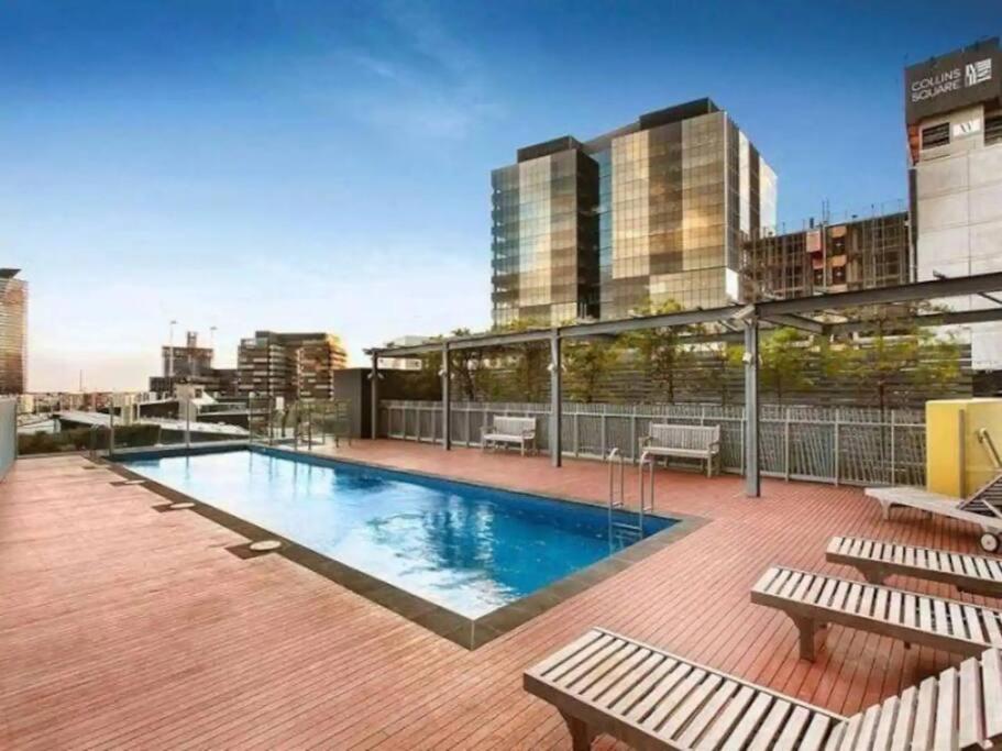 a swimming pool on the roof of a building at Docklands Convenient & Modern 1 Bed Apartment in Melbourne
