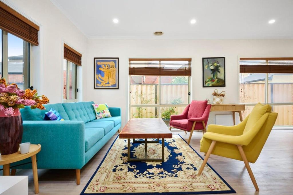 a living room with a blue couch and two chairs at Spacious Home in Newport in Newport