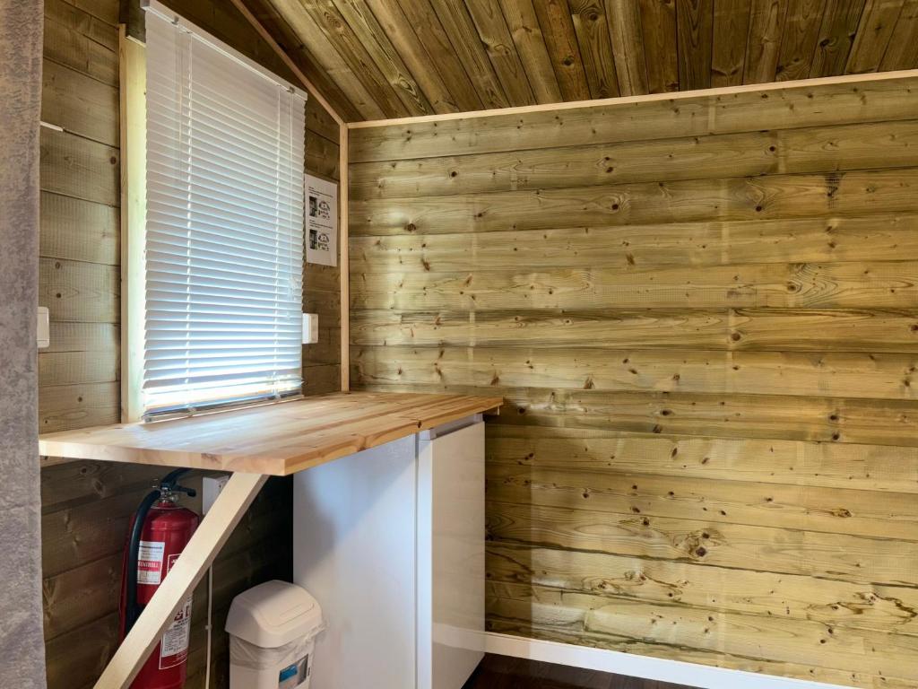 a log cabin with a wooden wall at Winjum Cabin Aurland Stegastein in Aurland
