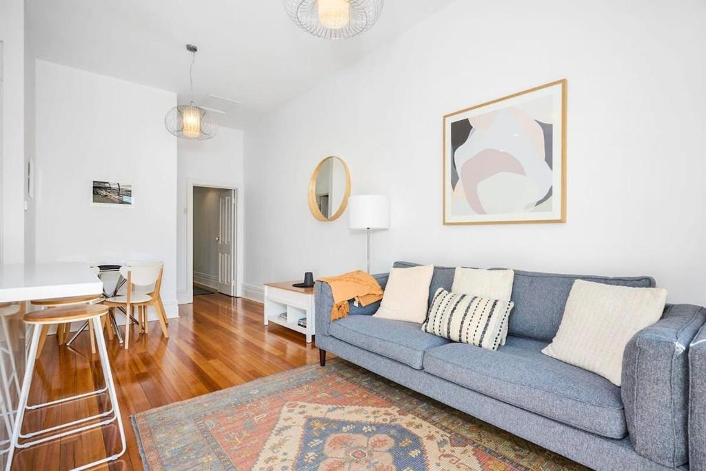 a living room with a couch and a table at Yarraville - Modern Historic Home in Yarraville