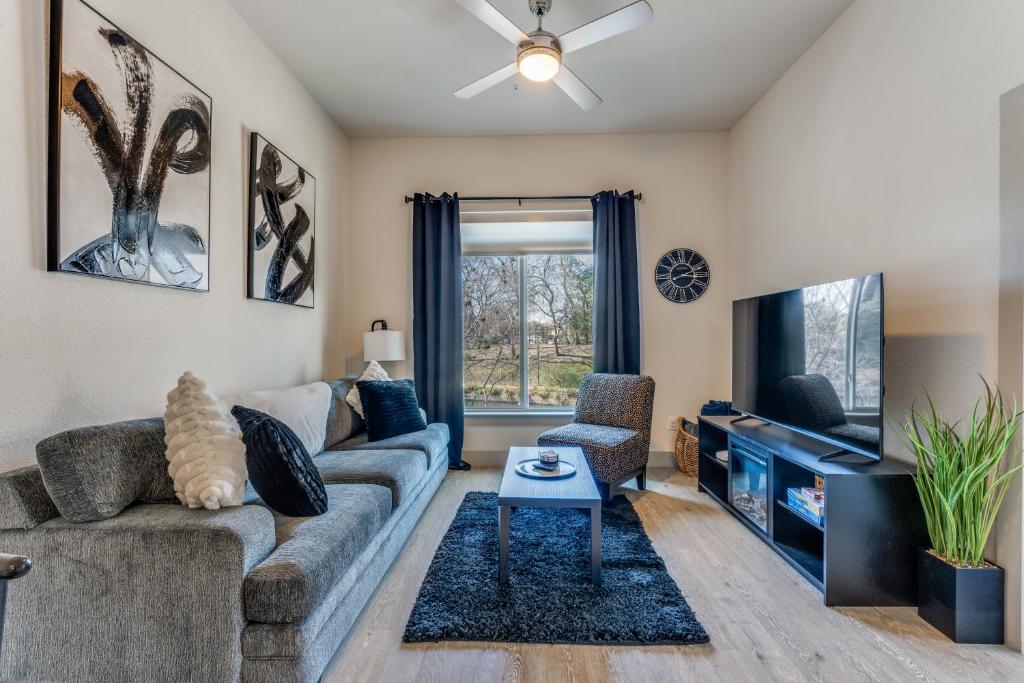 a living room with a couch and a tv at Spectacular Condo facing Riverwalk 1141 in San Antonio