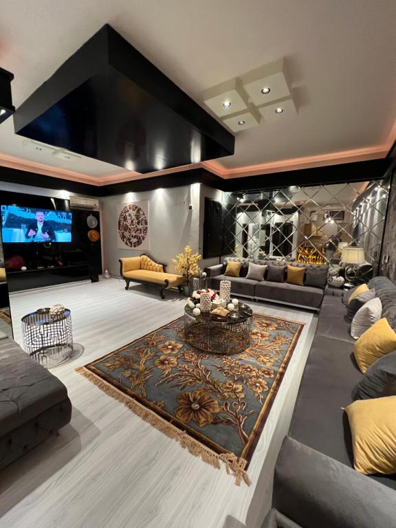 a large living room with couches and a tv at شقة غرفتين وصاله بتصميم مودرن in Riyadh