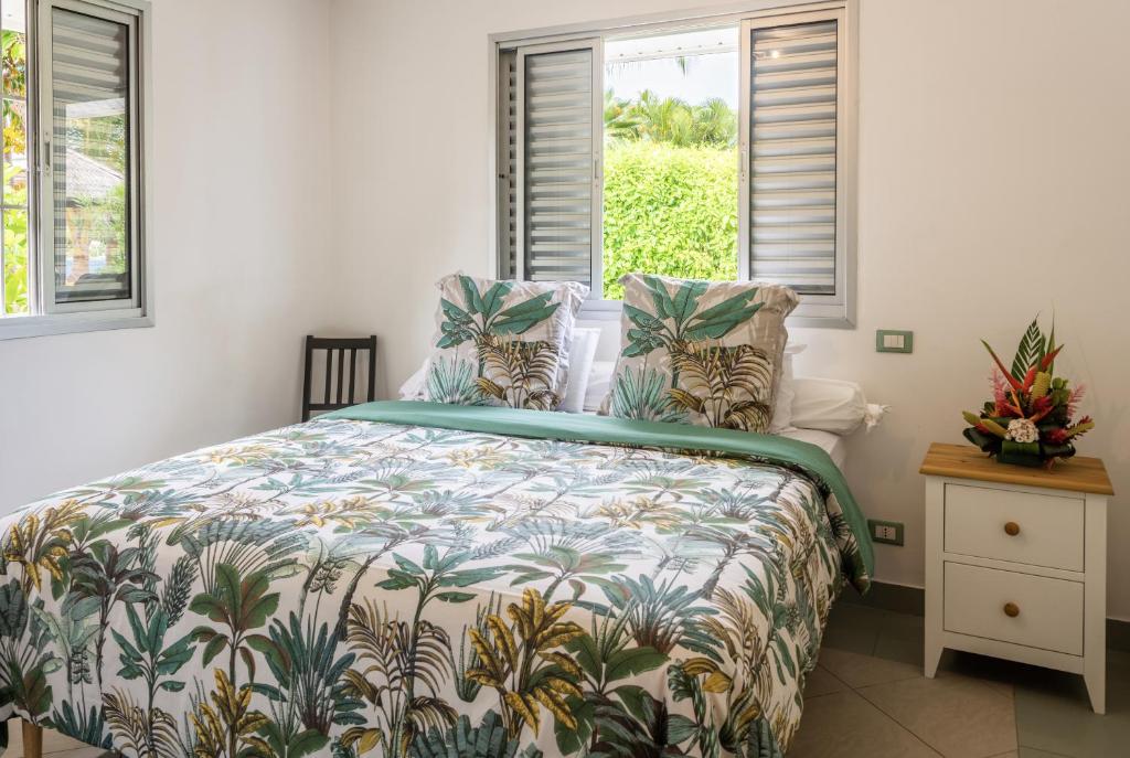 um quarto com uma cama com uma colcha tropical em PARADISE em Bora Bora