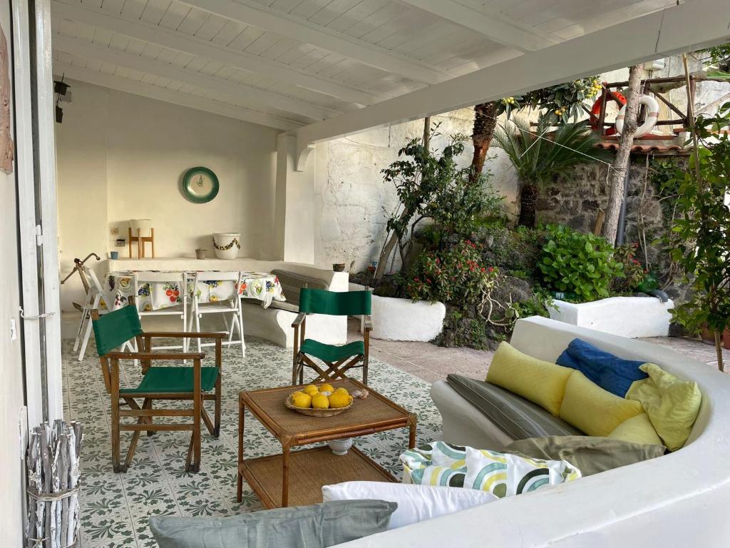 a living room with a couch and chairs at channel house in Ischia