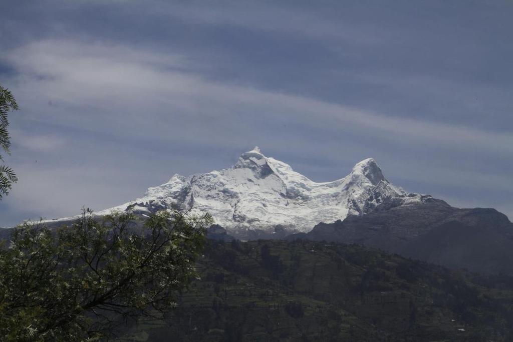 a snow covered mountain on top of a mountain at Almawasi Lodge in Yungay