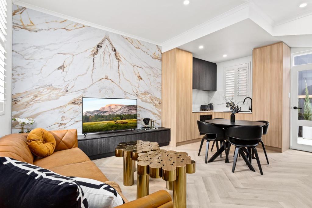 a living room with a couch and a table at Central 2-Bed Terrace House by the Harbour in Sydney