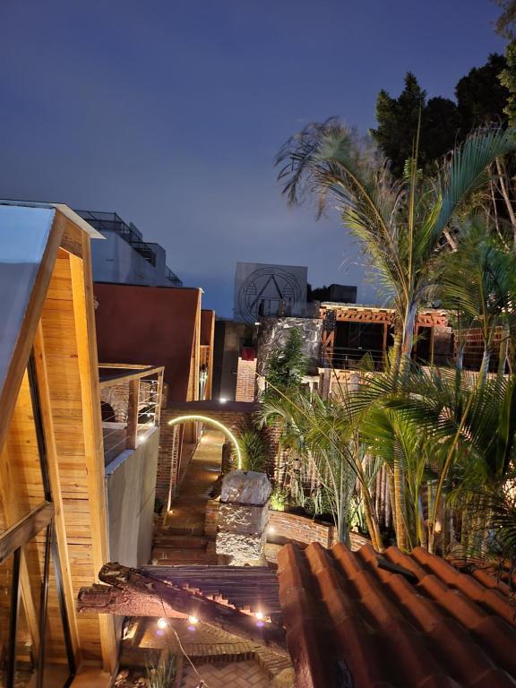 a stairway leading to a building with palm trees at Tinny Houses in El Gallinero