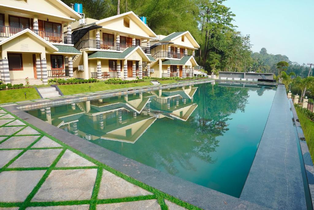 a swimming pool in front of a house at Muthanga Wild Resort in Muthanga