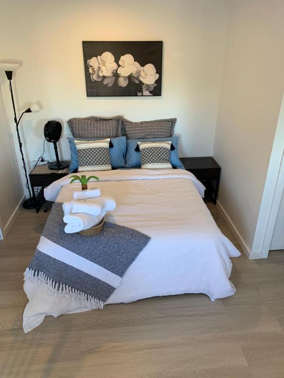 a bedroom with a large bed with towels on it at Cosy Secure comfortable for two in Canberra in Hall