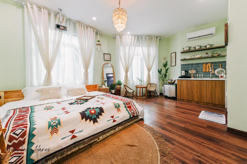 a bedroom with a large bed and a kitchen at MiaCasaHanoi in Hanoi