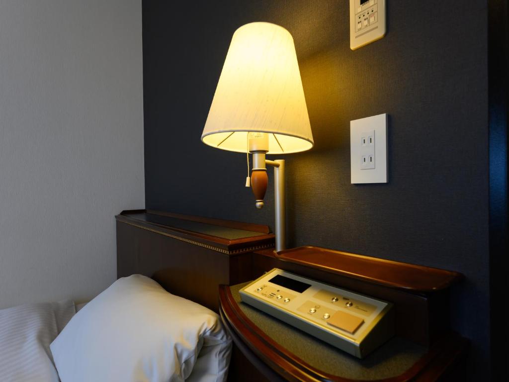Postel nebo postele na pokoji v ubytování Hotel Green Park Tsu