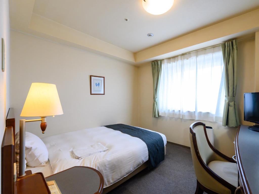 Postel nebo postele na pokoji v ubytování Hotel Green Park Tsu