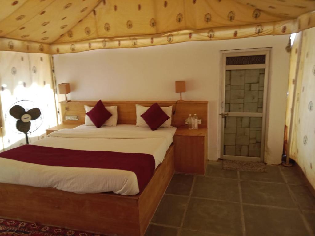 a bedroom with a large bed in a room at THE THAR DESERT CAMP SAM JAISLMER in Sām