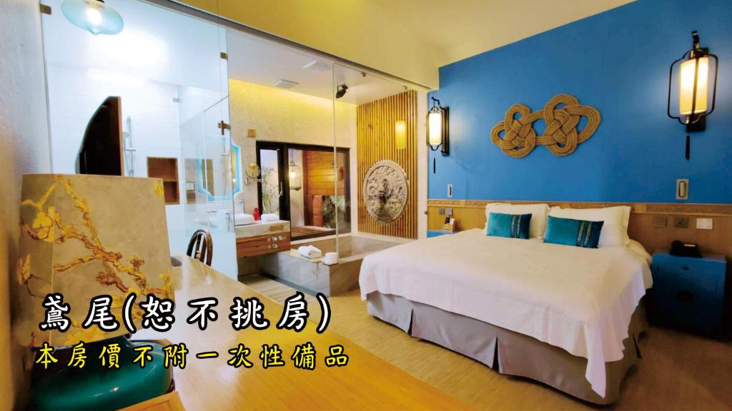 a hotel room with a bed and a mirror at Tingtau Villa in Lugu Lake