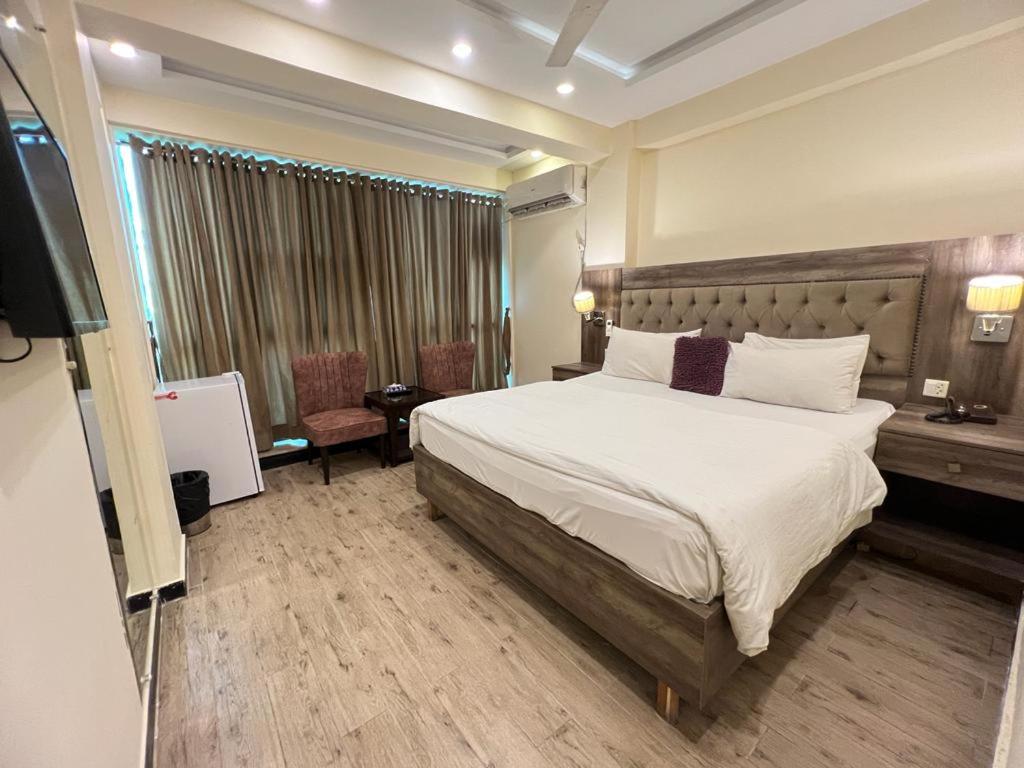 a hotel room with a bed and a television at Islamabad Premium Hotel in Islamabad