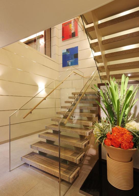 a staircase in a building with a potted plant at Keio Presso Inn Ikebukuro in Tokyo