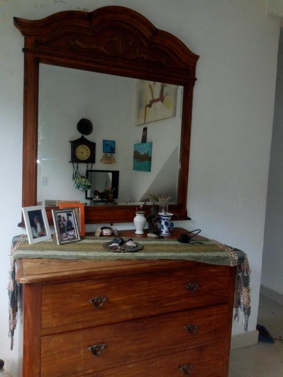 a dresser with a mirror on top of it at Xixova Hostel Japui são Vicente in Praia Grande