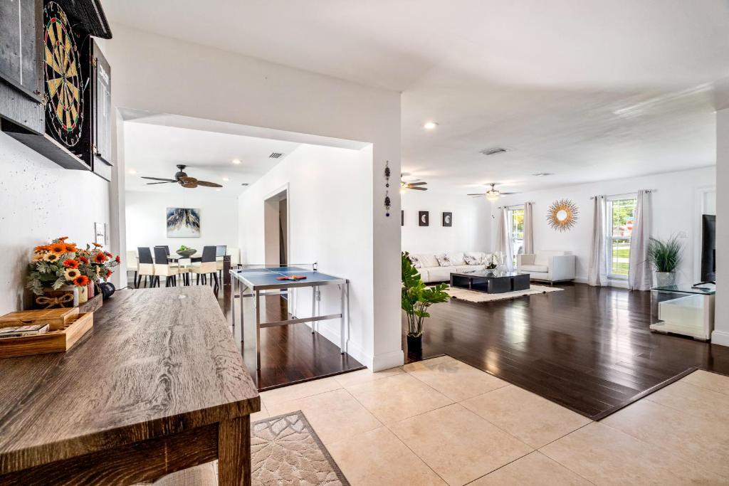 a large living room with a table in the middle at Gorgeous open concept 4 BR with heated pool and lounge area in Fort Lauderdale